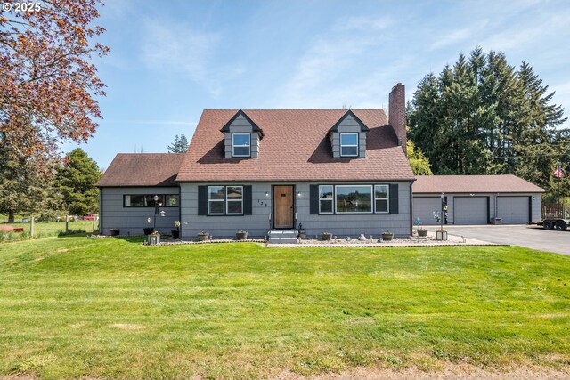136 Morton Rd, Winlock, WA 98596 - new england style home with a chimney, a shingled roof, a front yard, and a garage