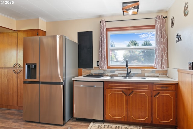 136 Morton Rd, Winlock, WA 98596 - kitchen featuring ornamental molding, light countertops, brown cabinets, a sink, and appliances with stainless steel finishes
