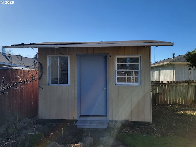 view of shed featuring fence