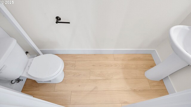 bathroom with toilet and baseboards