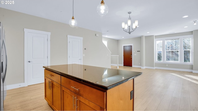 kitchen with light wood-style floors, recessed lighting, pendant lighting, and a center island