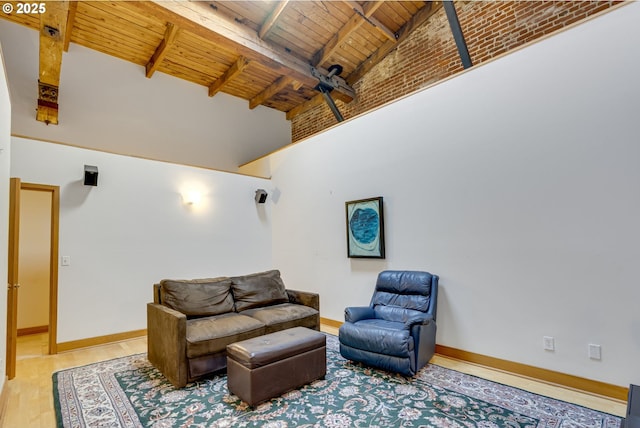 living area featuring baseboards, wood ceiling, wood finished floors, high vaulted ceiling, and beam ceiling