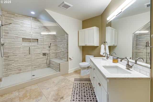 bathroom with toilet, a shower stall, visible vents, and a sink