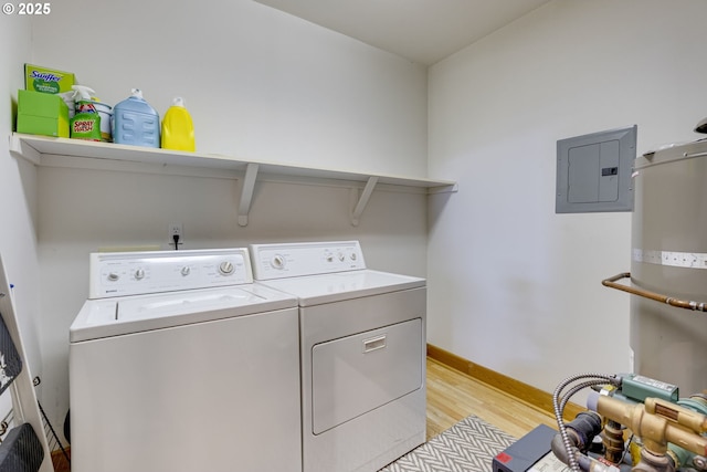 laundry room with laundry area, electric panel, baseboards, light wood-style flooring, and independent washer and dryer