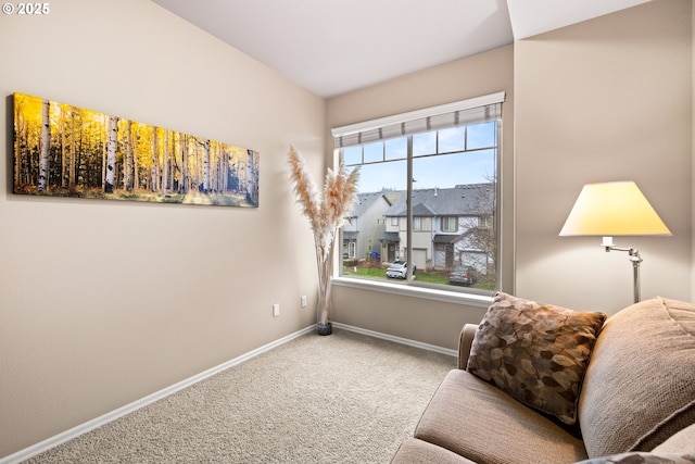 sitting room with carpet, a residential view, and baseboards