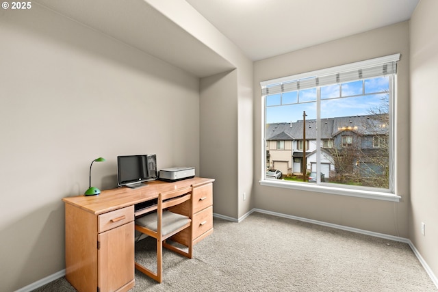 office area with light carpet and baseboards