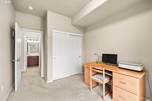office space with light carpet and baseboards
