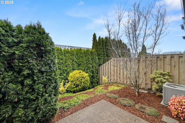 view of yard featuring a fenced backyard and central air condition unit