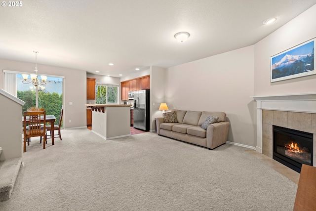 living room featuring recessed lighting, light carpet, a fireplace, and baseboards