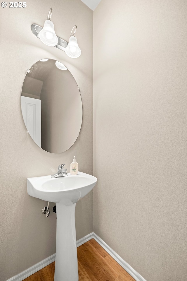 bathroom featuring wood finished floors and baseboards