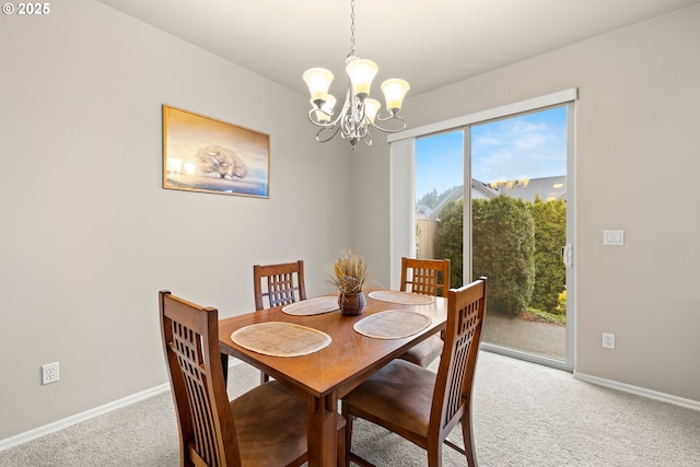 dining area with baseboards, an inviting chandelier, and light colored carpet