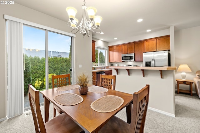 dining area featuring a notable chandelier, recessed lighting, light colored carpet, visible vents, and baseboards