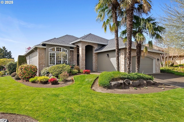 ranch-style home featuring roof with shingles, brick siding, aphalt driveway, an attached garage, and a front lawn