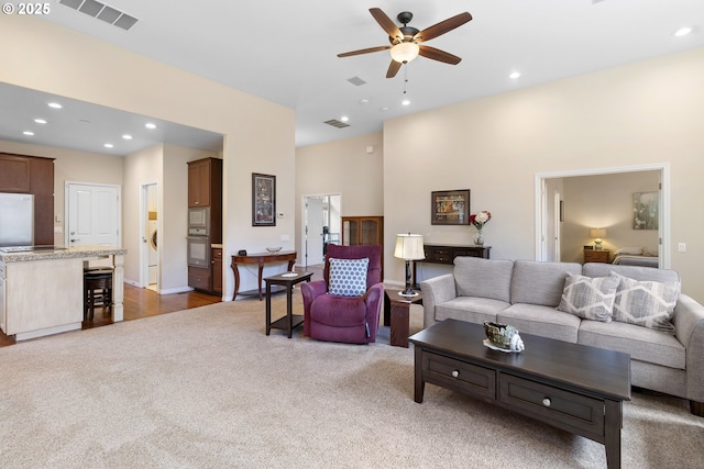 living area featuring visible vents, recessed lighting, carpet, and ceiling fan