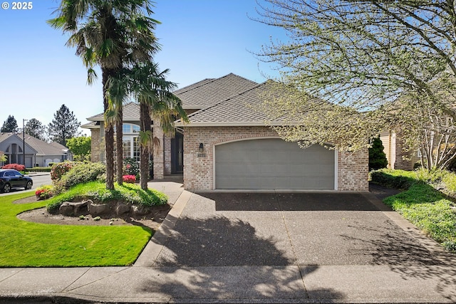french provincial home featuring brick siding, driveway, and a garage