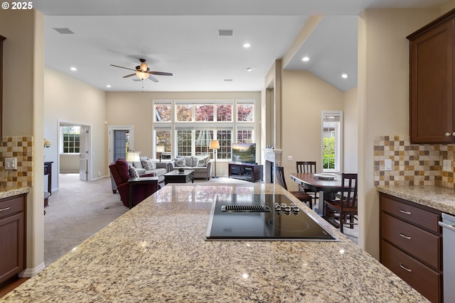 kitchen featuring plenty of natural light, open floor plan, black electric cooktop, and ceiling fan