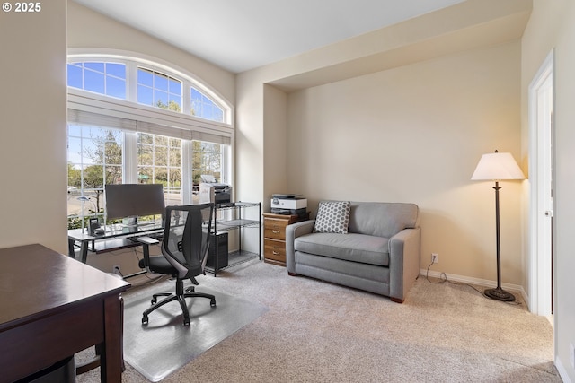 home office with baseboards and light carpet