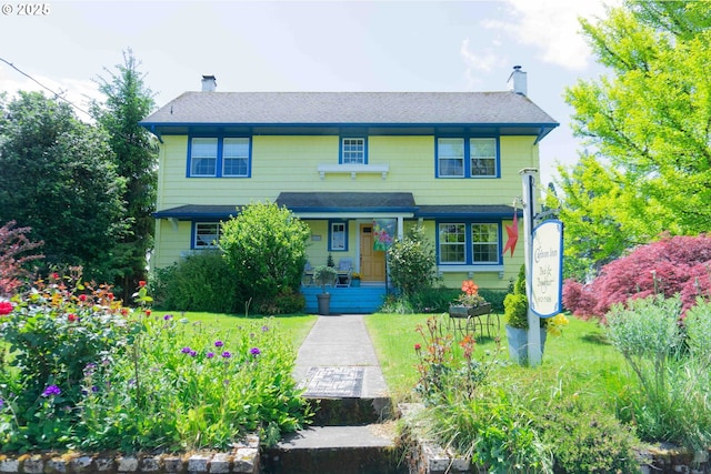 648 W Main St, Carlton, OR 97111 - view of front of house featuring a chimney, a porch, a front lawn, and a shingled roof