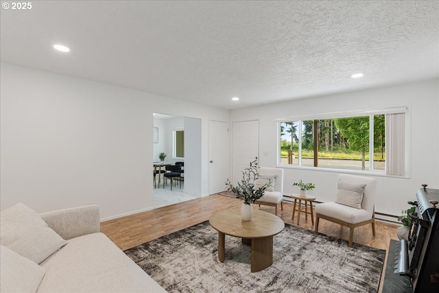 3434 Memorial Park Dr, Longview, WA 98632 - living area with light wood-style floors, recessed lighting, a textured ceiling, and baseboard heating