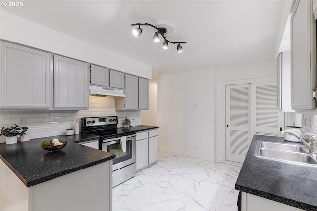 3434 Memorial Park Dr, Longview, WA 98632 - kitchen with stainless steel electric stove, under cabinet range hood, backsplash, and dark countertops