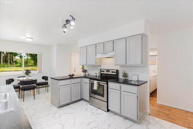3434 Memorial Park Dr, Longview, WA 98632 - kitchen featuring stainless steel electric range oven, under cabinet range hood, backsplash, a peninsula, and gray cabinets