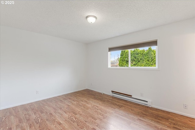 3434 Memorial Park Dr, Longview, WA 98632 - spare room with a baseboard radiator, wood finished floors, and a textured ceiling