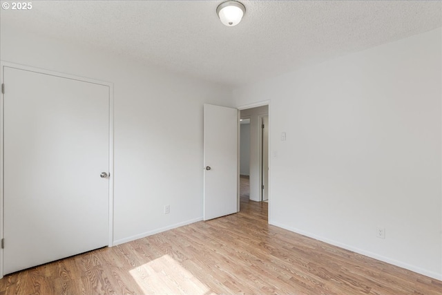 3434 Memorial Park Dr, Longview, WA 98632 - unfurnished bedroom featuring light wood finished floors and a textured ceiling