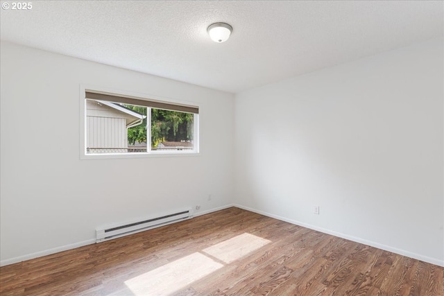 3434 Memorial Park Dr, Longview, WA 98632 - unfurnished room featuring a baseboard radiator and wood finished floors
