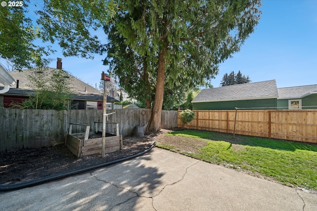 view of yard featuring a fenced backyard and a vegetable garden