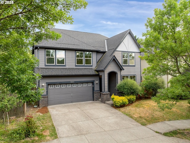 18840 SW Westland Ln, Beaverton, OR 97003 - view of front facade featuring a garage, concrete driveway, brick siding, and a shingled roof