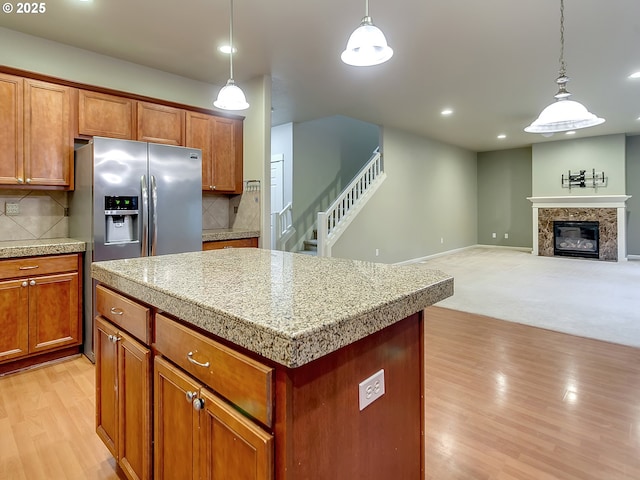 18840 SW Westland Ln, Beaverton, OR 97003 - kitchen with light wood-style floors, a kitchen island, backsplash, pendant lighting, and recessed lighting