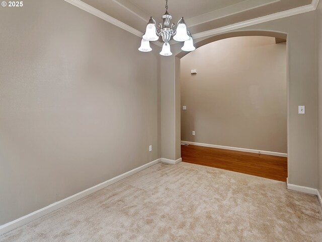 18840 SW Westland Ln, Beaverton, OR 97003 - carpeted empty room with arched walkways, a chandelier, and crown molding