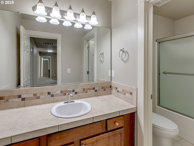 18840 SW Westland Ln, Beaverton, OR 97003 - bathroom featuring vanity, bath / shower combo with glass door, tile patterned flooring, and tasteful backsplash
