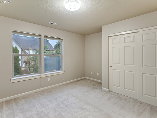 18840 SW Westland Ln, Beaverton, OR 97003 - unfurnished bedroom featuring light colored carpet, a textured ceiling, and a closet