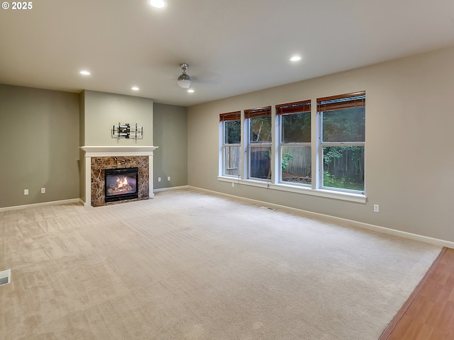 18840 SW Westland Ln, Beaverton, OR 97003 - unfurnished living room featuring recessed lighting, a premium fireplace, a ceiling fan, and wood finished floors