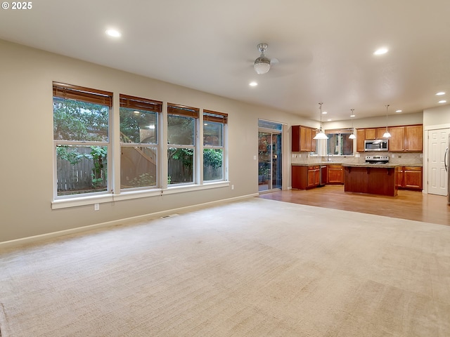18840 SW Westland Ln, Beaverton, OR 97003 - unfurnished living room with recessed lighting, a ceiling fan, light colored carpet, and healthy amount of natural light