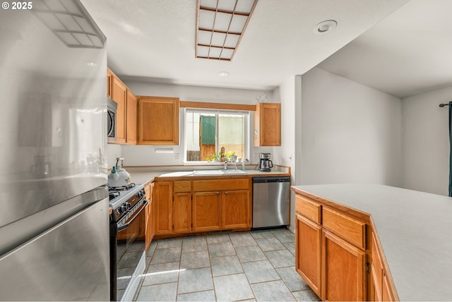 1232 E Fourth Ave, Sutherlin, OR 97479 - kitchen featuring appliances with stainless steel finishes, light countertops, and brown cabinets