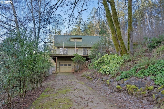 view of front of house with a wooden deck and a garage