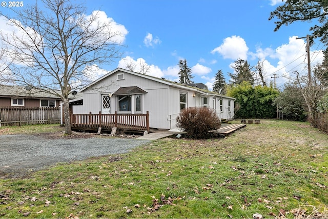 exterior space featuring a deck and a front lawn