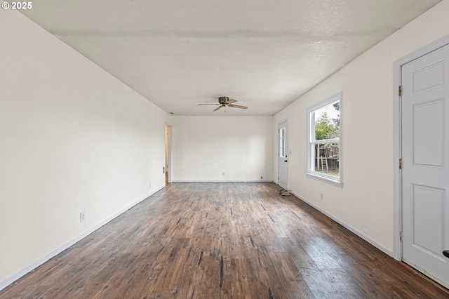 spare room with ceiling fan and dark hardwood / wood-style flooring