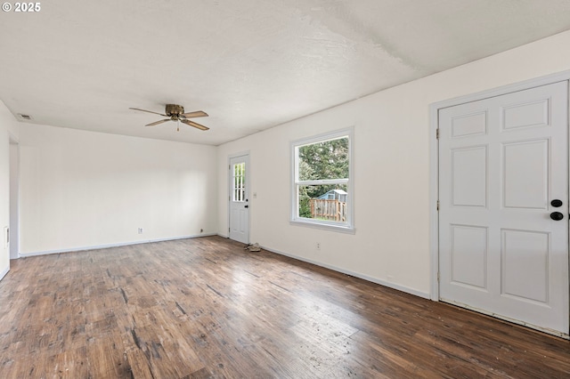 spare room featuring dark hardwood / wood-style flooring and ceiling fan