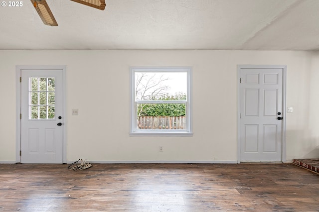 foyer with ceiling fan, a textured ceiling, and dark hardwood / wood-style flooring