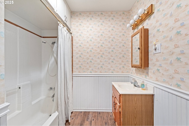 bathroom with shower / bathtub combination with curtain, hardwood / wood-style floors, and vanity