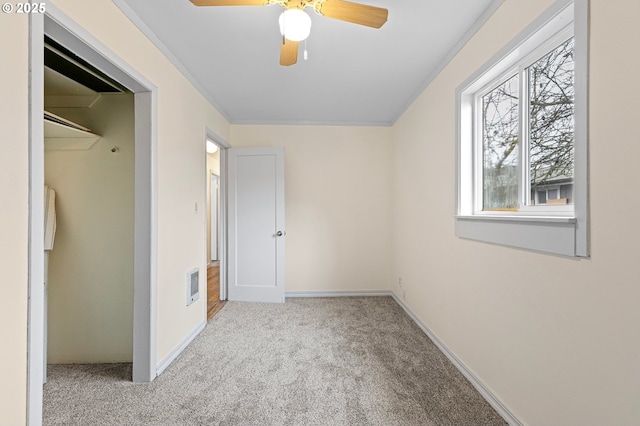 unfurnished bedroom featuring light carpet and ceiling fan