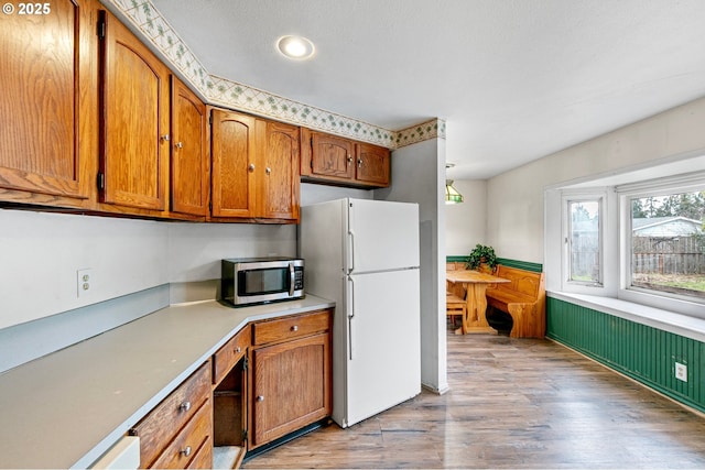 kitchen with light wood-type flooring and white fridge