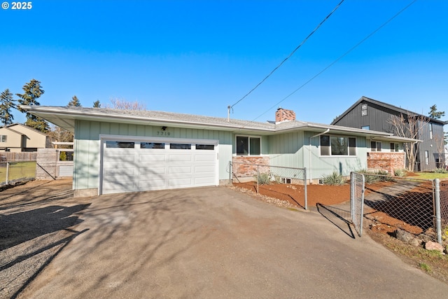 single story home with driveway, a chimney, an attached garage, and fence