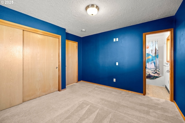 unfurnished bedroom featuring a textured ceiling and carpet flooring