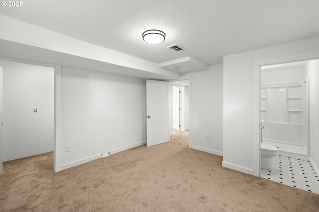 unfurnished bedroom with baseboards, carpet flooring, a textured ceiling, and visible vents