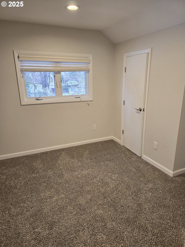 spare room with lofted ceiling and carpet