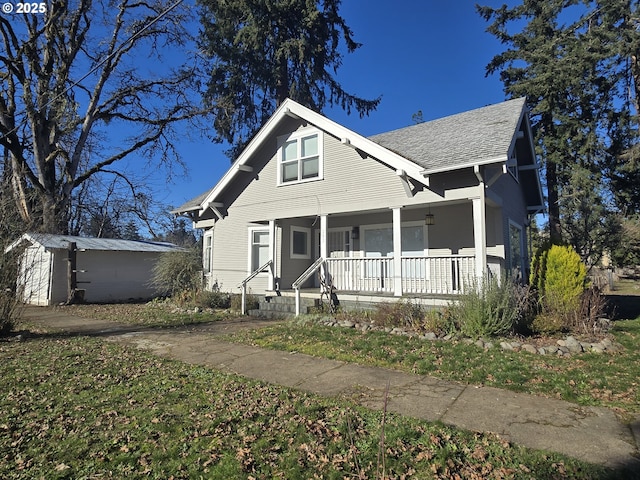 bungalow featuring a storage unit and covered porch